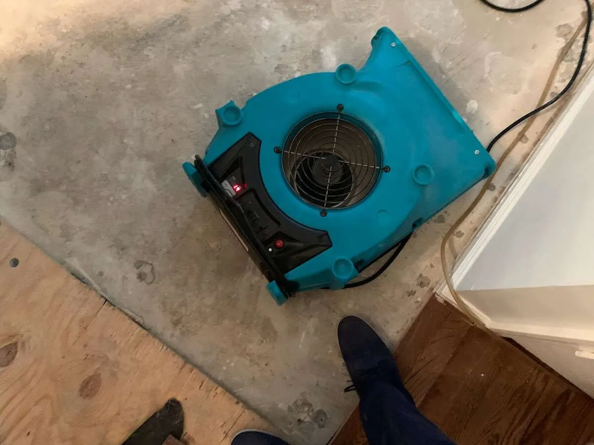 Air mover drying subfloor during Commercial Water Damage Restoration in Moultonborough